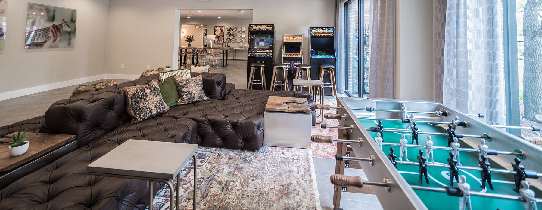 Large game room with large windows and foosball tables