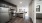 Spacious and well lit kitchen with wood floors and stainless steel appliances. 